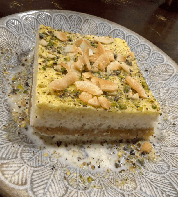Coconut and apricot delight dessert topped with pistachio and almond flakes