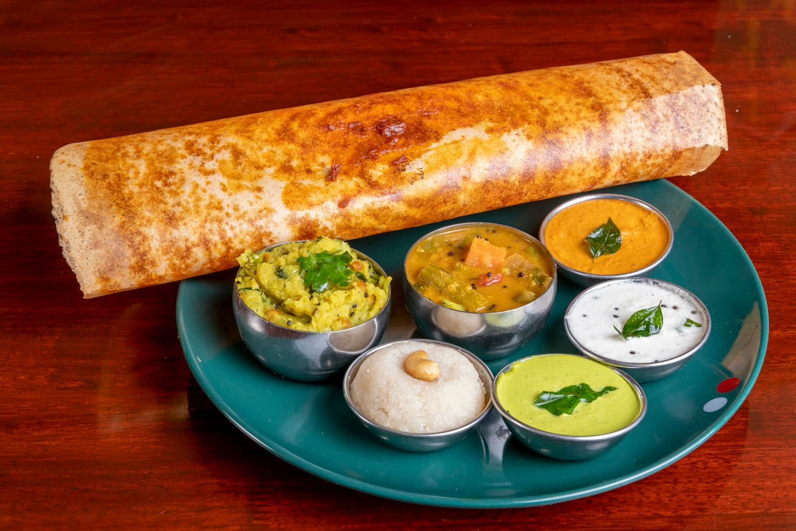 Crisp benne dosa served on a banana leaf at Kopparrai, Hauz Khas
